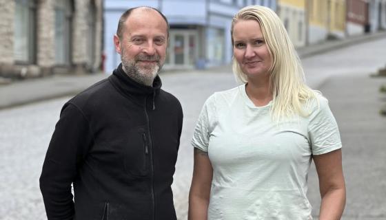 Mann og kvinne står i bybildet i Ålesund og smiler til fotografen.